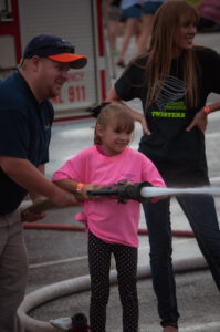 Christina Smith age 8 having fun with the fire hose