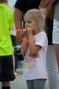 Little Larisa Moore waiting on her brothers to get off a ride at the Family Fun Fest