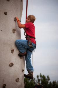 Dawson James making his way up the rock wall