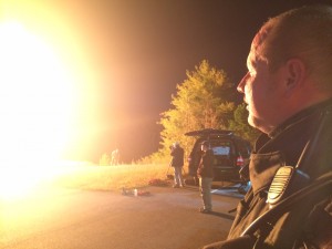 Clarkesville Fire Chief Jerry Palmer looks on as firefighters extinguish an LP tank fire during an exhibition/training exercise Thursday night.