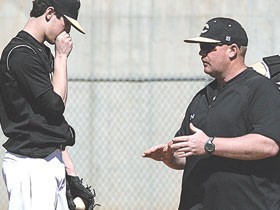 Coach Carl Allen from his high school playing days with local prep spot Commerce as he receives advice from Coach Steve Cotrell.