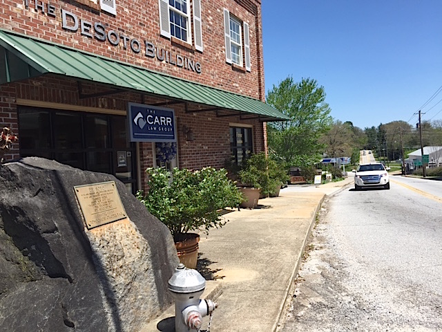 The de Soto historical marker sits to the side of its namesake, the DeSoto Building.