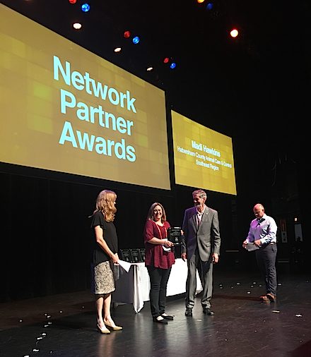Madi Hawkins on stage with Best Friends Lifesaving Luminary Award copy