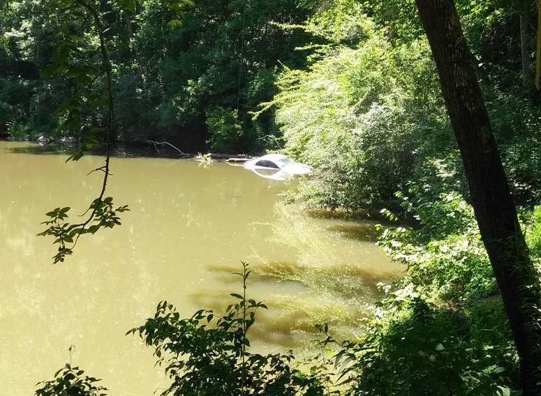 car rolls into creek in white county