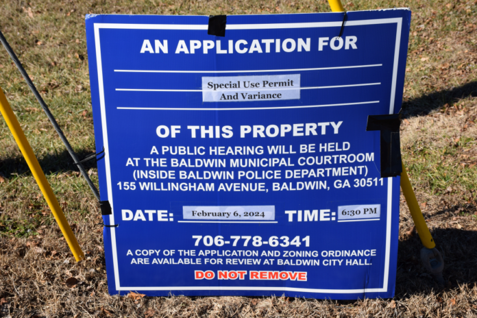 Baldwin public hearing sign