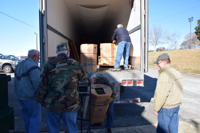 Vets unload truck Wreaths Across America