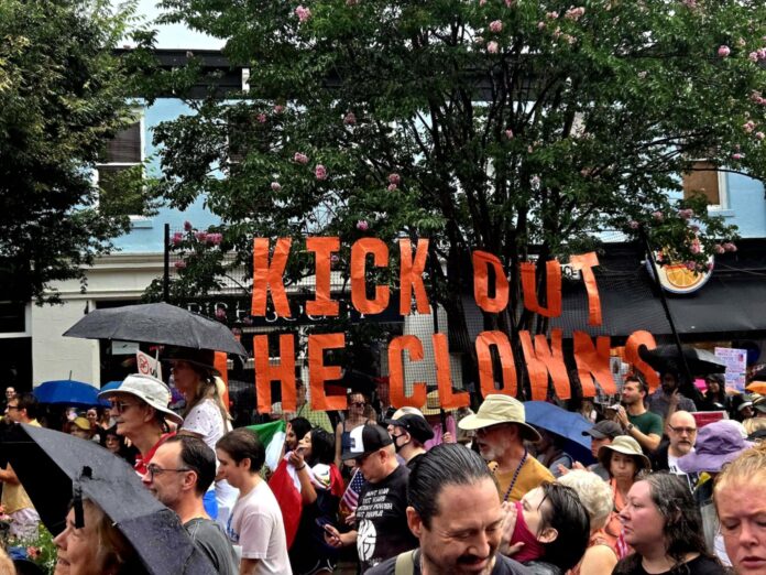 Athens protest KICK OUT THE CLOWNS banner