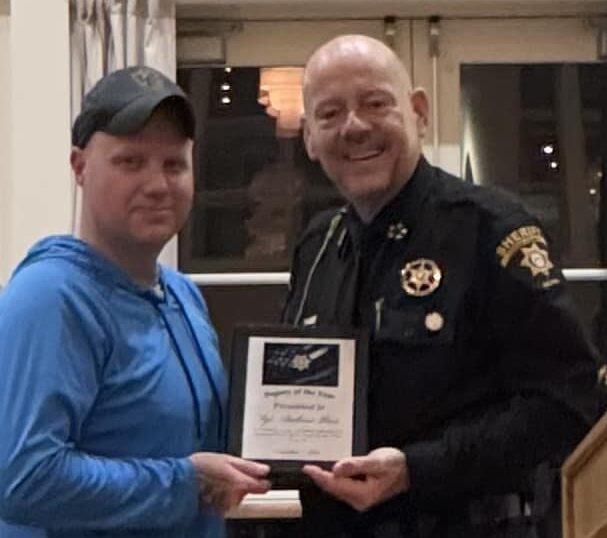 Andrew Glass (left) accepting Officer of the year award from Former Sheriff Ken Henderson on Dec 11th 2025. 