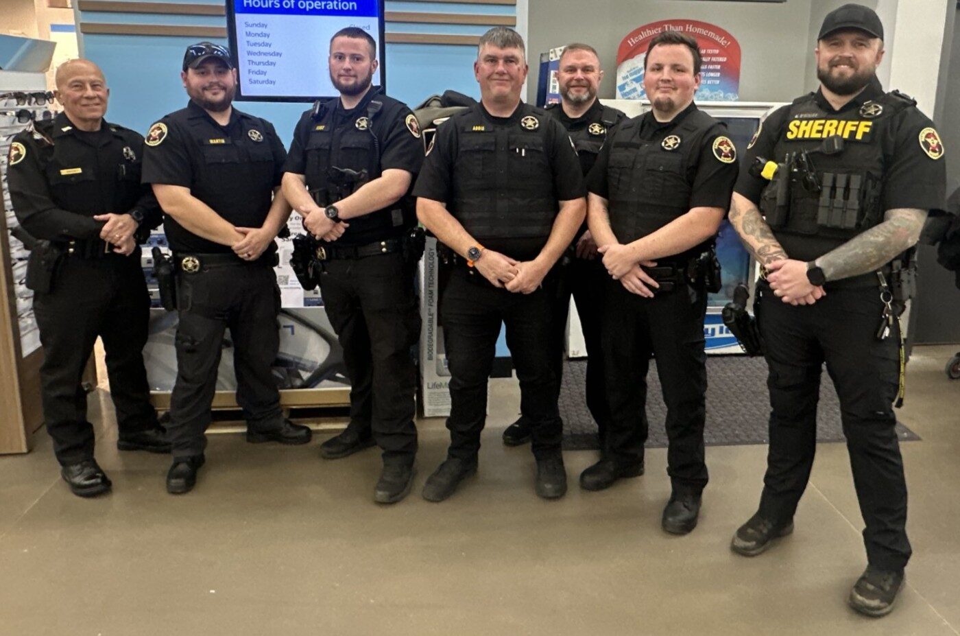 Pausing during the recent Habersham County Sheriff’s Office Shop with a Hero event in Cornelia are, from left, SRO Anthony Sullo, SRO Austin Martin, SRO Kristopher Stout, SRO Sgt. Wesley Addis, SRO Lt. Aaron Autry, SRO Joel Compton, and SRO Kyle O’Kelley.